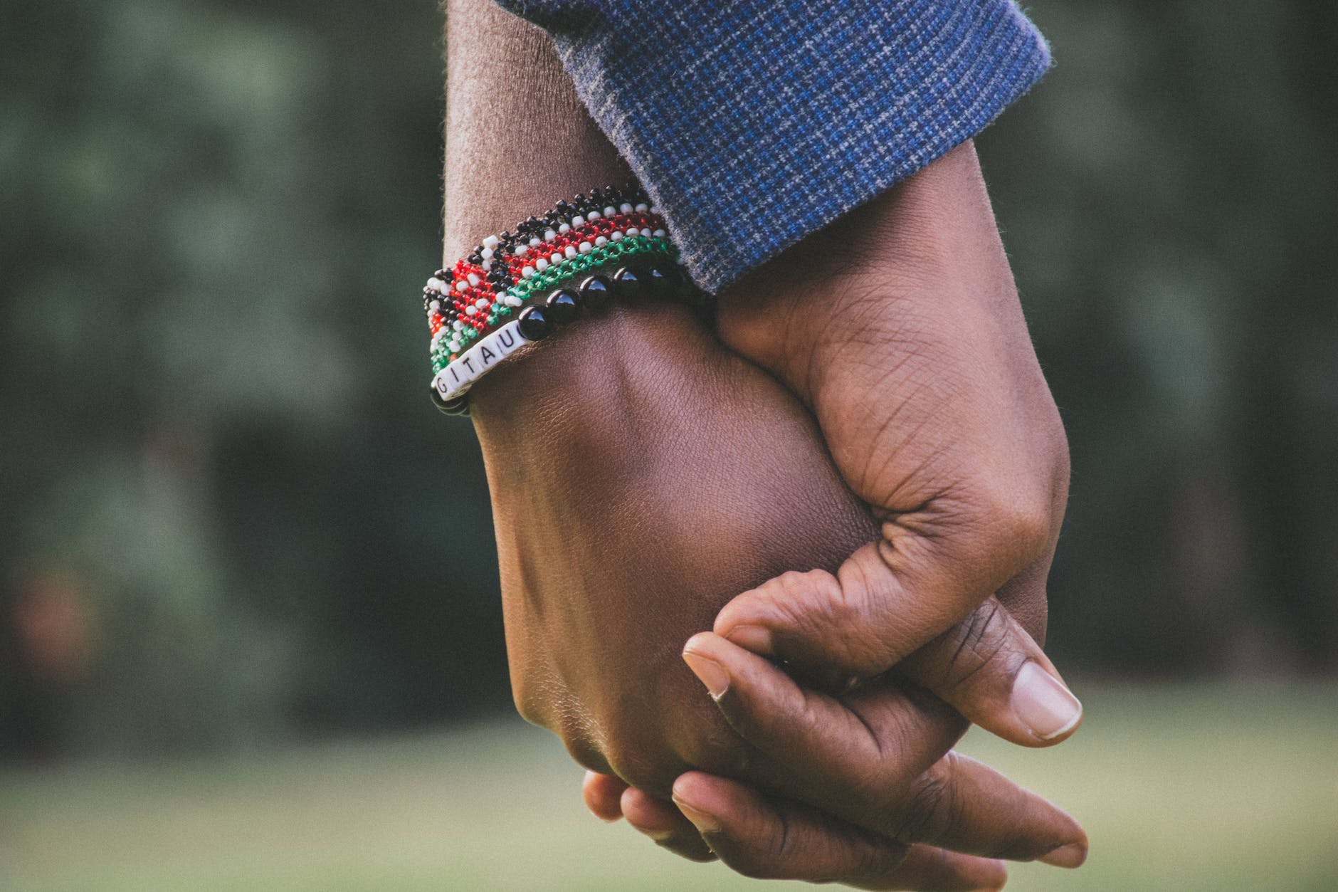 close up photo of two person s holding hands