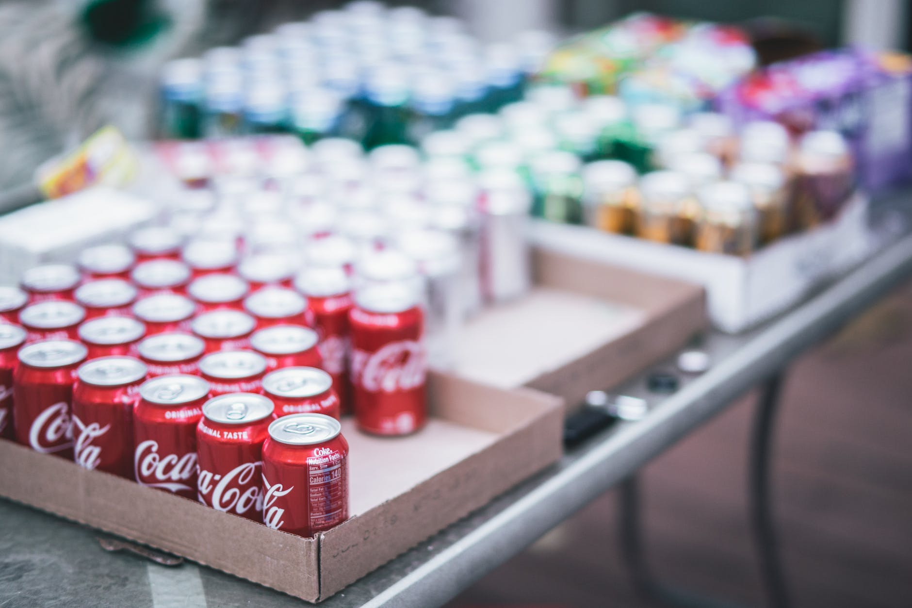 selective focus photography of red coca cola can lot on box