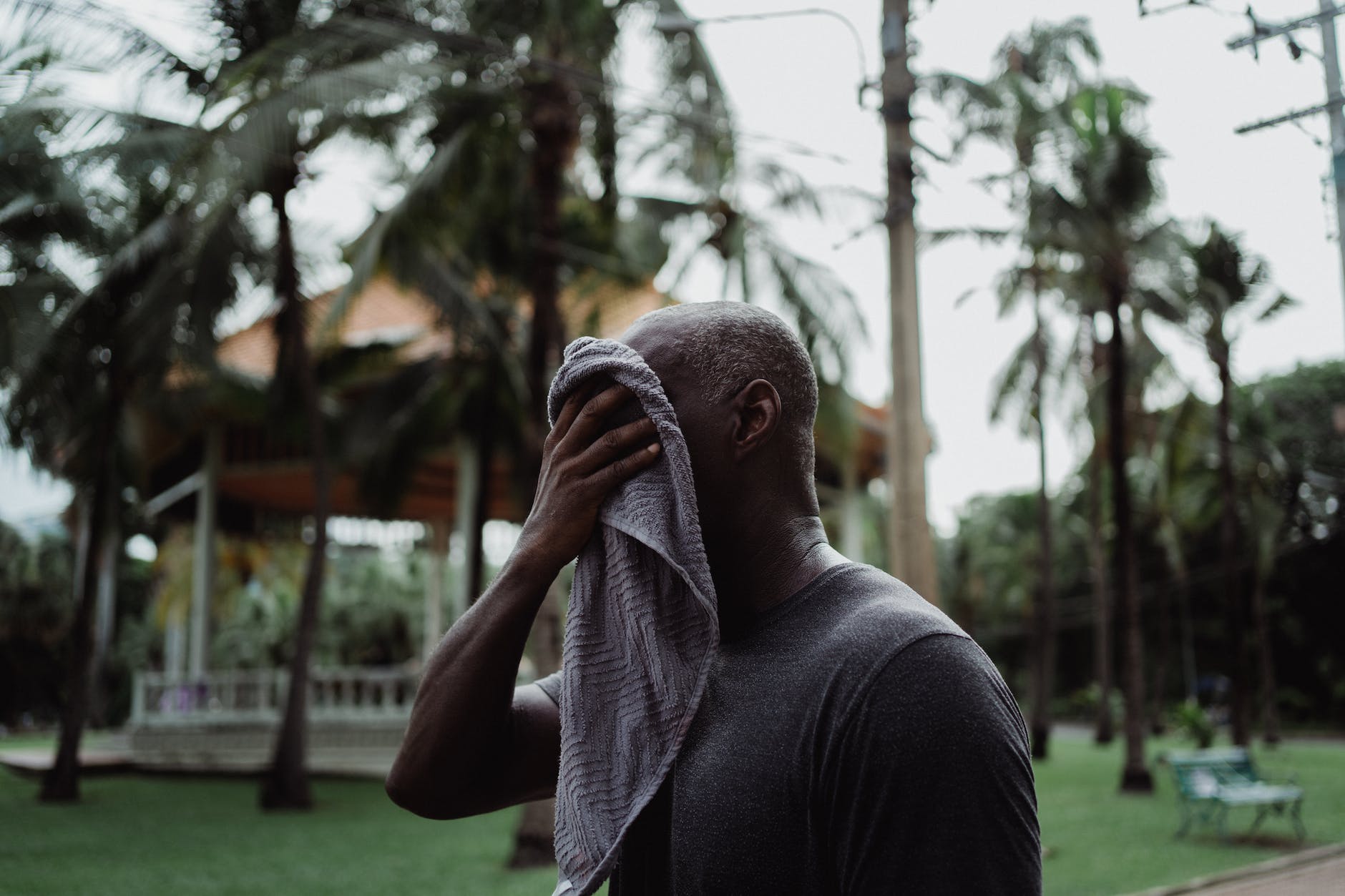 man wiping his face with a towel