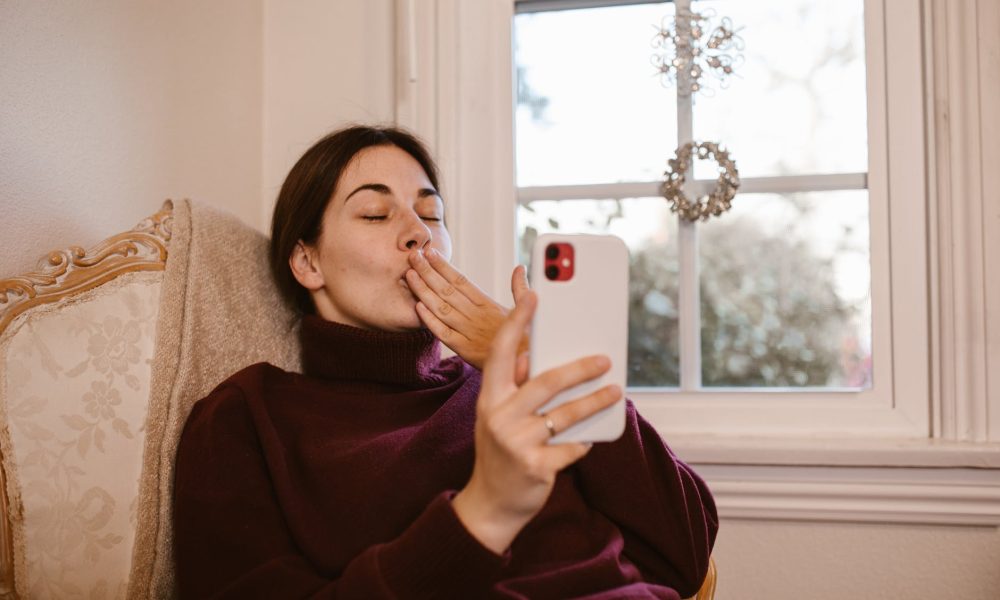 woman sitting on chair while having a video call