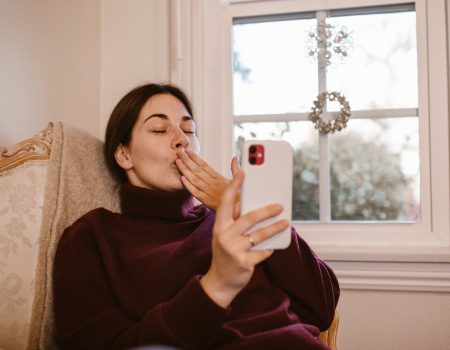woman sitting on chair while having a video call