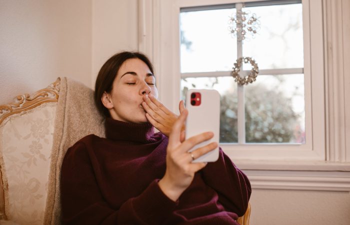 woman sitting on chair while having a video call