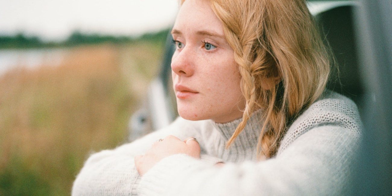 woman in white sweater thinking