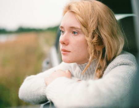 woman in white sweater thinking