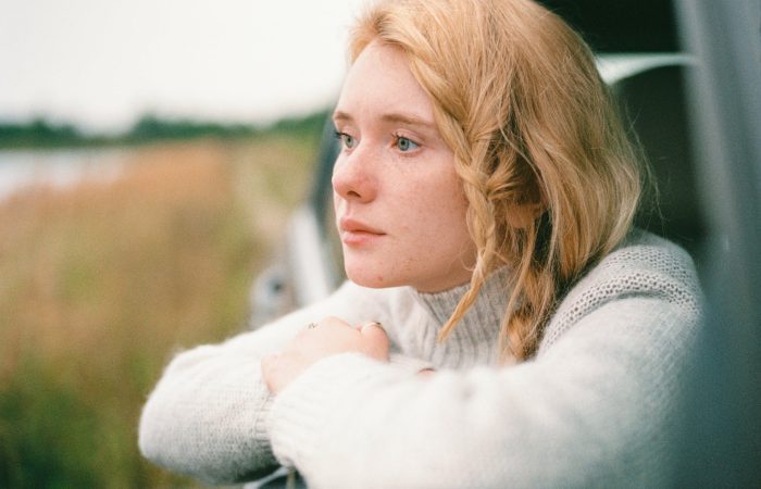 woman in white sweater thinking