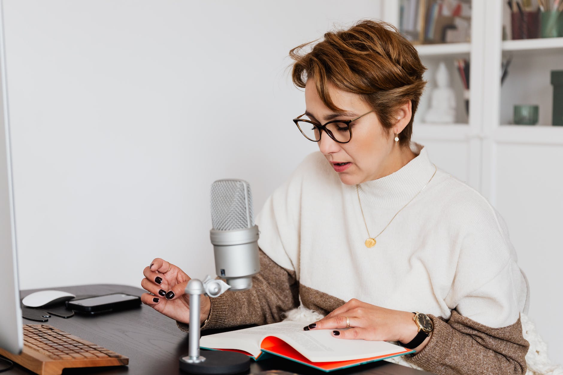 woman narrating story while recording audiobook