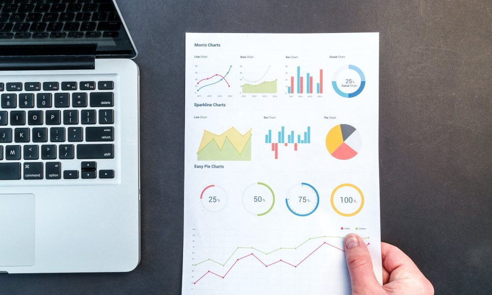 person holding chart and bar graph