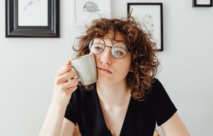 curly haired woman holding a coffee mug