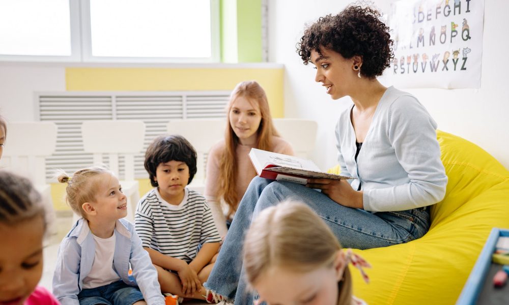 woman reading a book to the children