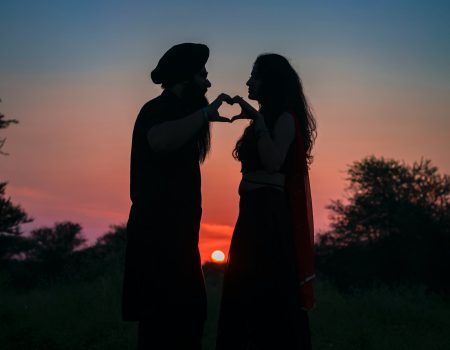 silhouette photo of couple making a heart shape
