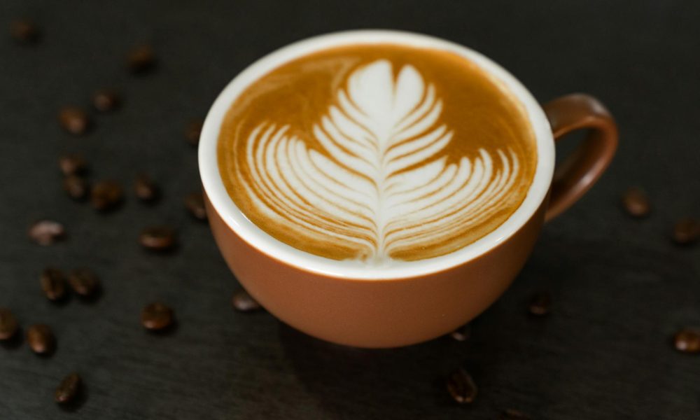 fresh brew of cafe latte in a brown mug