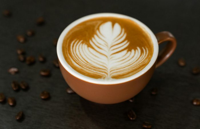 fresh brew of cafe latte in a brown mug