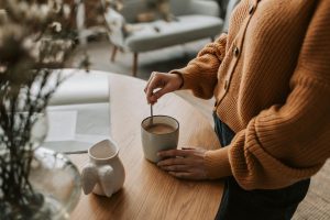 a person mixing a drink in a mug