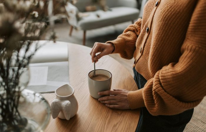 a person mixing a drink in a mug