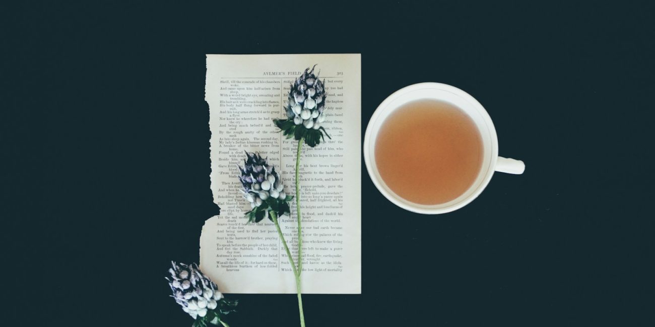 white ceramic tea cup beside white flowers