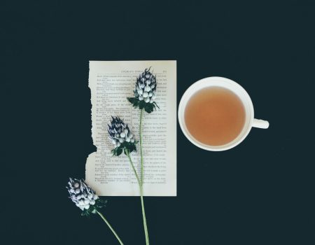 white ceramic tea cup beside white flowers