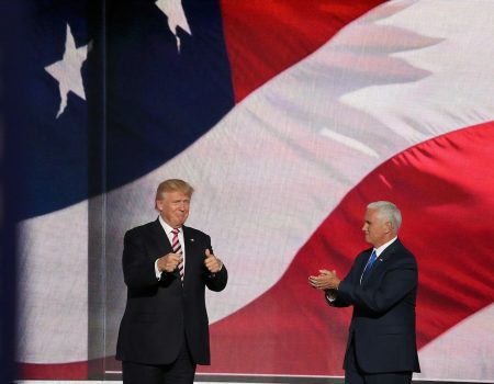 Donald Trump beside man in black suit