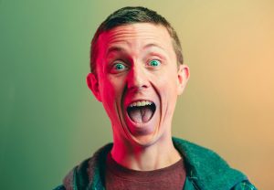 man in green crew neck shirt smiling
